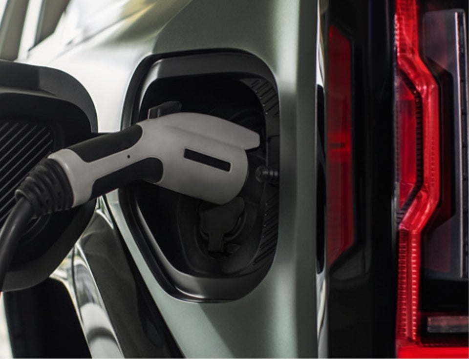 Close up of charging port with charger plugged in on a GMC Hummer EV SUV - Charbonneau Car Center in Dickinson ND